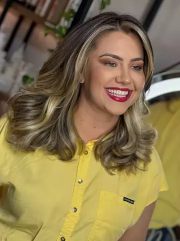 Cliente loira com mechas iluminadas e blusa amarela